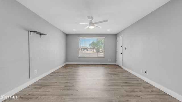 empty room featuring baseboards, ceiling fan, and wood finished floors