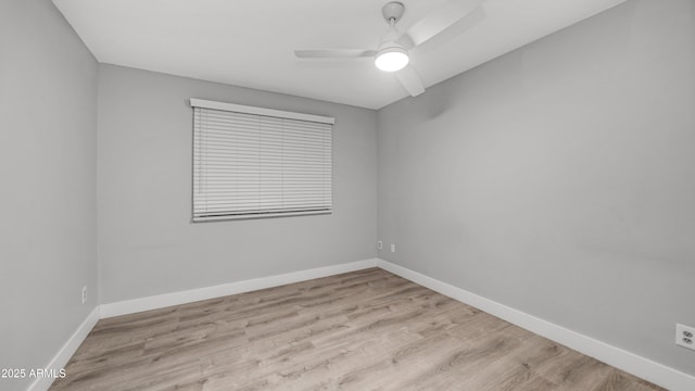 unfurnished room with baseboards, a ceiling fan, and wood finished floors
