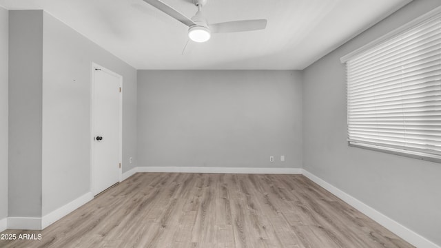 empty room featuring ceiling fan, baseboards, and light wood-type flooring