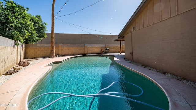 view of swimming pool with a fenced backyard and a fenced in pool