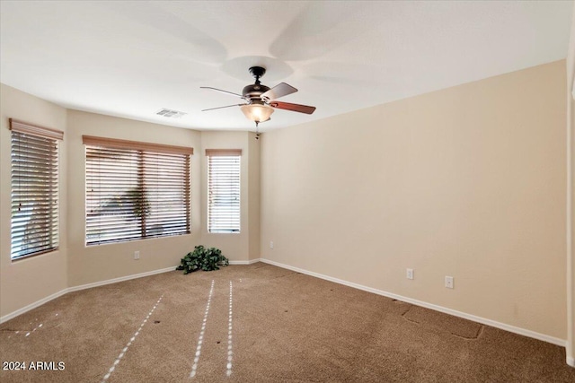 unfurnished room with ceiling fan and light colored carpet