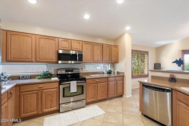 kitchen featuring appliances with stainless steel finishes and light tile patterned floors