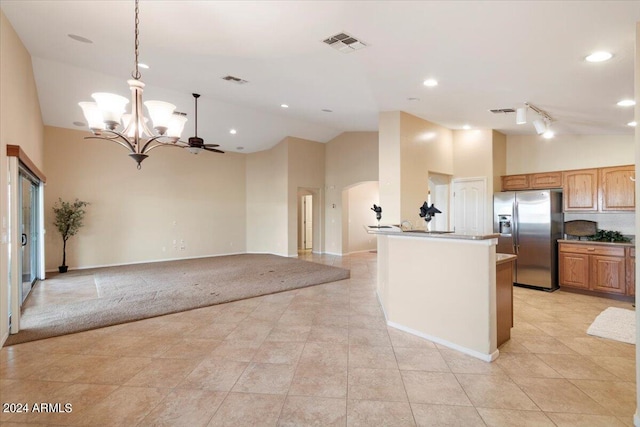 kitchen with light tile patterned flooring, high vaulted ceiling, pendant lighting, and stainless steel refrigerator with ice dispenser