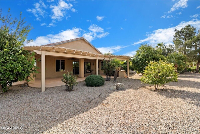 back of house with a pergola, ceiling fan, and a patio