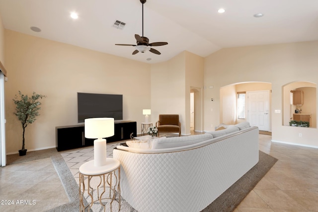 living room featuring ceiling fan, light tile patterned floors, and high vaulted ceiling