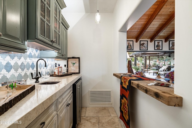 kitchen with lofted ceiling with beams, sink, hanging light fixtures, light stone countertops, and wooden ceiling