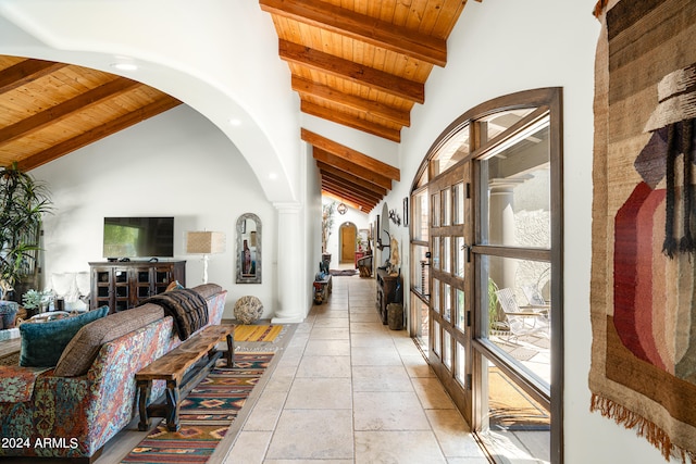 hall featuring wooden ceiling, beam ceiling, high vaulted ceiling, and decorative columns