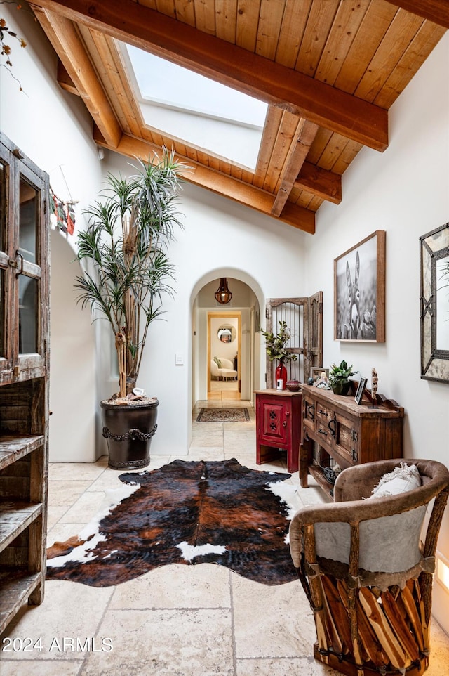 interior space with wooden ceiling and lofted ceiling with beams