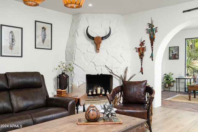 living room with light wood-type flooring and a fireplace