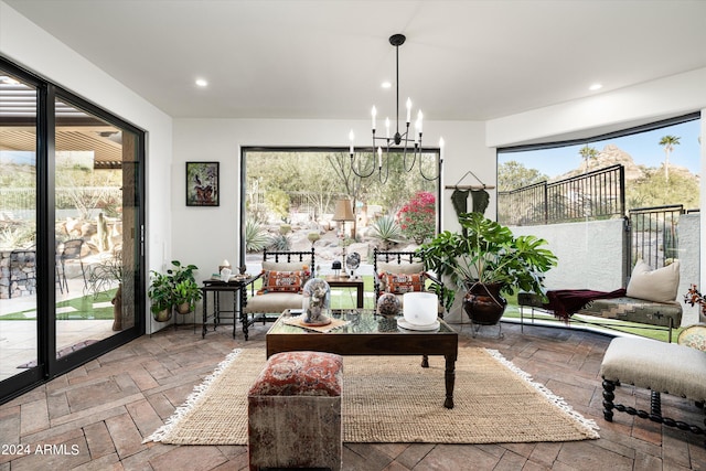 sunroom / solarium with a chandelier