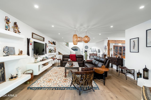 living room featuring light hardwood / wood-style floors and a chandelier