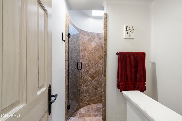 bathroom with a shower with door