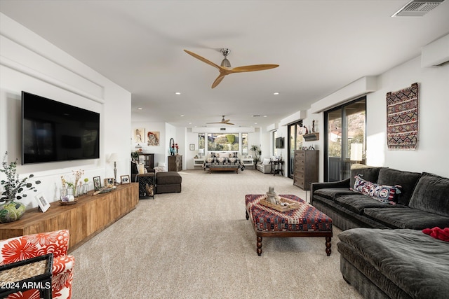 living room featuring ceiling fan and light colored carpet