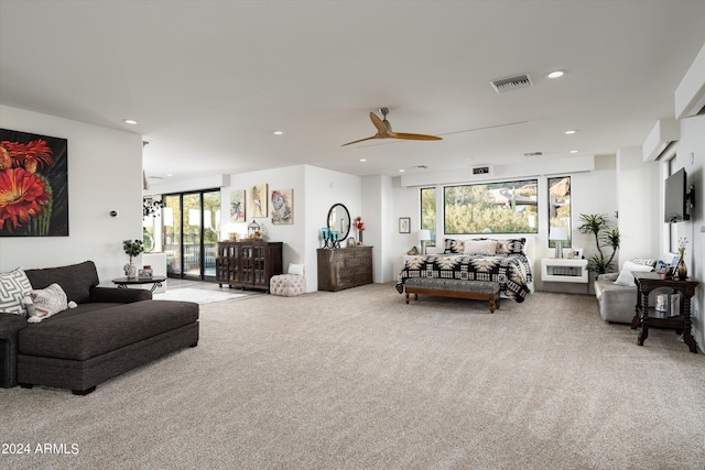 carpeted living room with ceiling fan