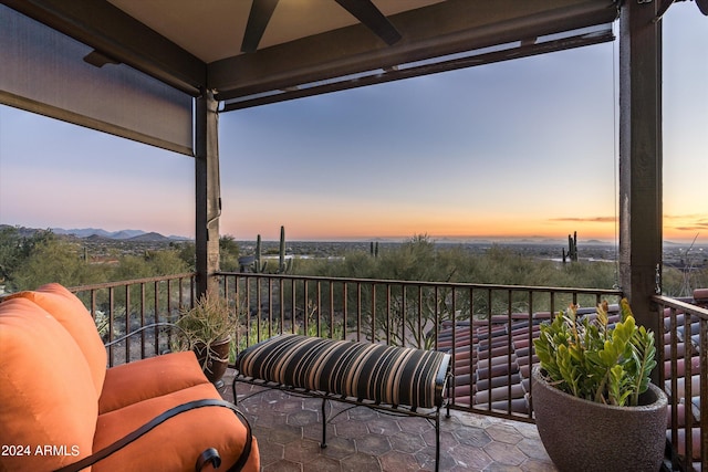 balcony at dusk featuring a mountain view