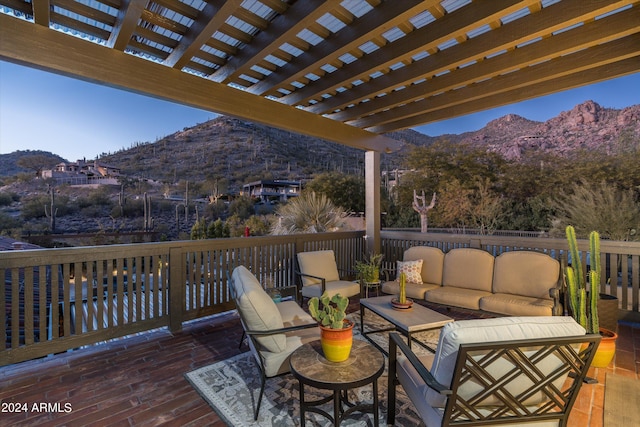 deck with an outdoor hangout area, a pergola, and a mountain view