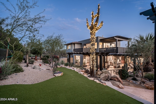 view of yard featuring a pergola, a balcony, and a patio