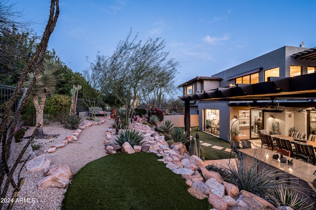 view of yard with ceiling fan and a patio