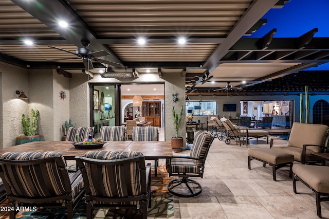 dining area with ceiling fan and beamed ceiling