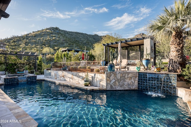 view of pool featuring a pergola, a mountain view, a patio area, exterior bar, and an in ground hot tub