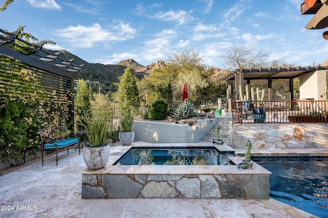 view of patio with a pool with hot tub, a pergola, and a mountain view