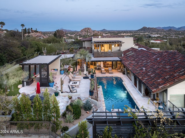 exterior space with a patio area, a mountain view, and an outdoor bar