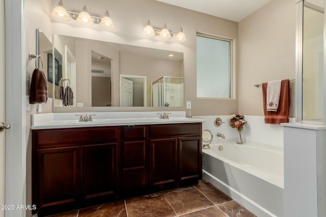 full bath with a sink, a shower stall, a bath, and double vanity