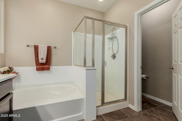 full bathroom featuring tile patterned floors, a bath, and a stall shower