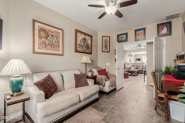 tiled living area featuring visible vents and a ceiling fan