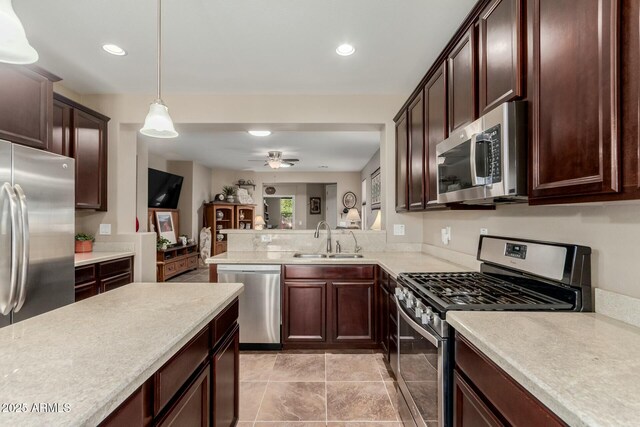 kitchen with a sink, light countertops, dark brown cabinetry, and stainless steel appliances