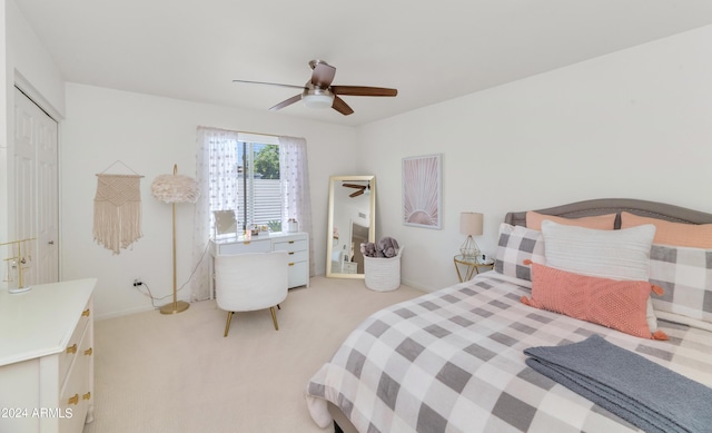 carpeted bedroom with ceiling fan and a closet