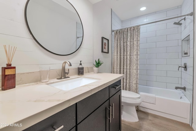 full bathroom featuring wood-type flooring, vanity, toilet, and shower / bath combo with shower curtain