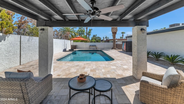 view of swimming pool with ceiling fan and a patio area