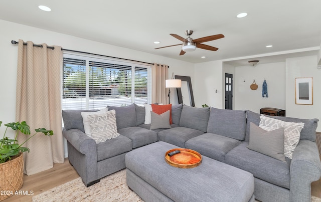 living room with ceiling fan and light hardwood / wood-style flooring