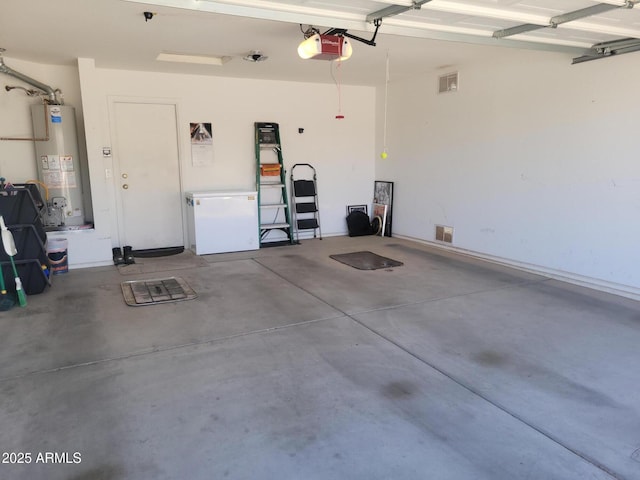 1769 E Jacob St, San Tan Valley, AZ 85140 - garage with gas water heater, a garage door opener, and refrigerator