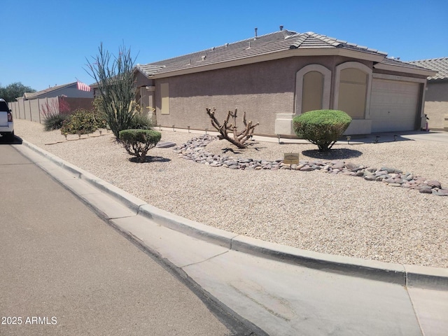1769 E Jacob St, San Tan Valley, AZ 85140 - view of front of home featuring stucco siding, an attached garage, a tile roof, fence, and driveway