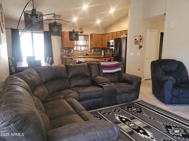 1769 E Jacob St, San Tan Valley, AZ 85140 - living area featuring vaulted ceiling, healthy amount of natural light, and light carpet
