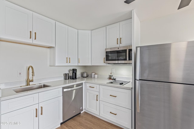 2033 E Janice Way, Phoenix, AZ 85022 - kitchen featuring appliances with stainless steel finishes, a sink, white cabinetry, light countertops, and light wood-type flooring