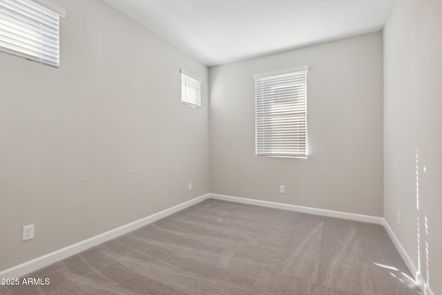 carpeted empty room with baseboards