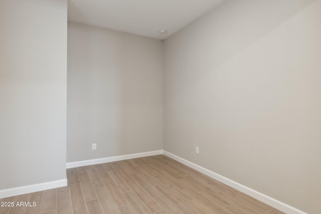 unfurnished room featuring light wood-style flooring and baseboards