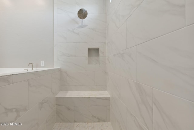 bathroom with a tile shower