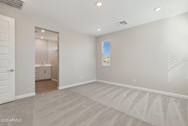 unfurnished bedroom with light carpet, visible vents, recessed lighting, and baseboards