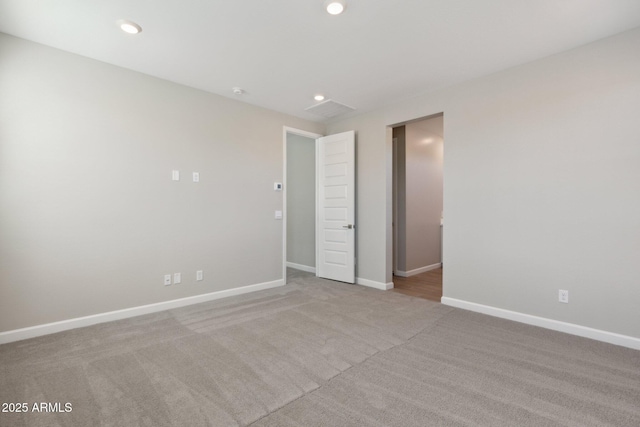 carpeted empty room with recessed lighting and baseboards