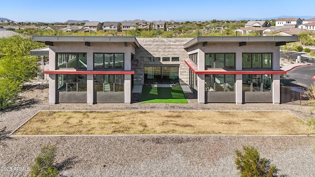 exterior space featuring a residential view and stucco siding