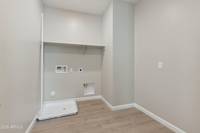 clothes washing area with laundry area, hookup for a washing machine, hookup for an electric dryer, and wood finish floors