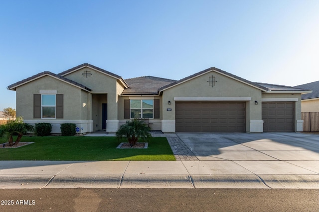 single story home featuring a garage and a front lawn