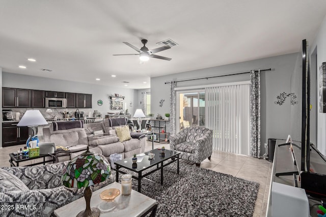 tiled living room with ceiling fan