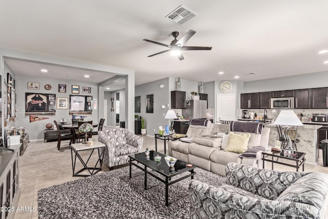 living room with light tile patterned flooring and ceiling fan