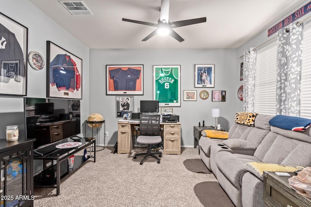 carpeted home office featuring ceiling fan