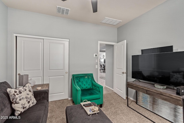 living room featuring carpet floors and ceiling fan